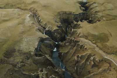 High angle view stream amidst mountains