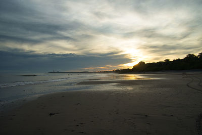 Scenic view of beach against sky during sunset