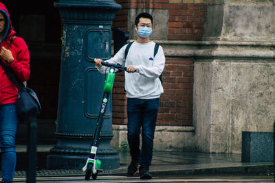 Full length of man standing against building