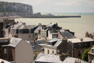 High angle view of houses by sea against sky