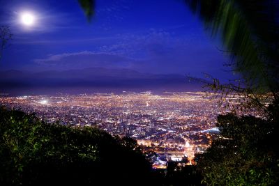 High angle view of illuminated buildings in city at night