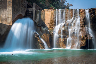 Smooth long exposure of waterfall. creamy beautiful waterfall falling off a cliff in the mountas.