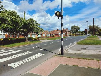 View of street against cloudy sky