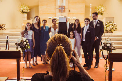 Rear view of people sitting at table