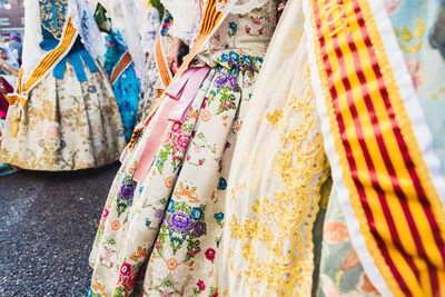 Multi colored clothes hanging in store for sale in market