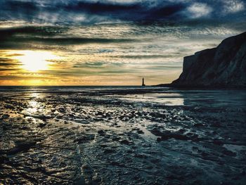 Scenic view of sea against cloudy sky