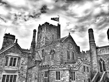 Low angle view of historical building against cloudy sky