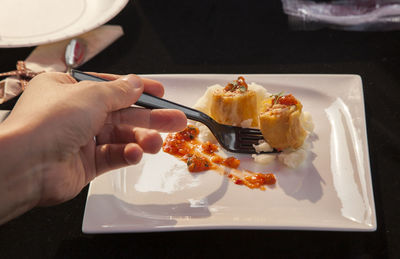 Cropped image of person having food served on table