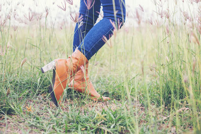 Low section of woman on field