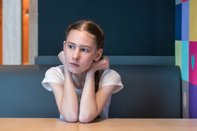 Portrait of woman sitting on table