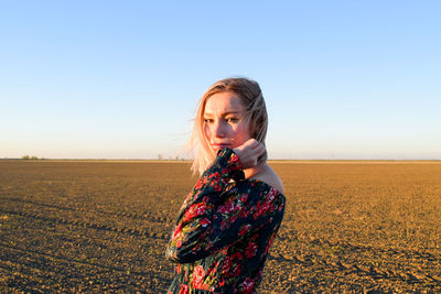 Full length of woman on field against clear sky