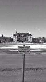 Information sign against sky