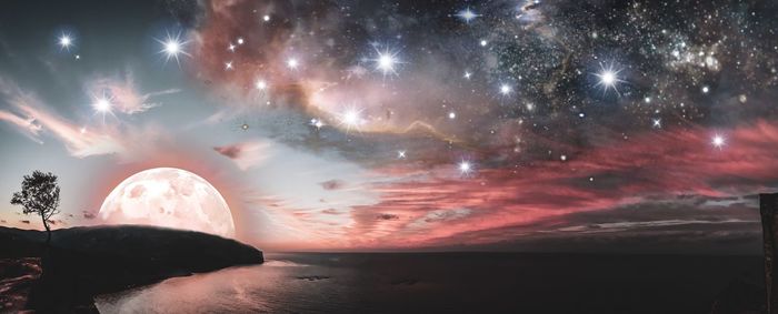 Scenic view of sea against sky at night