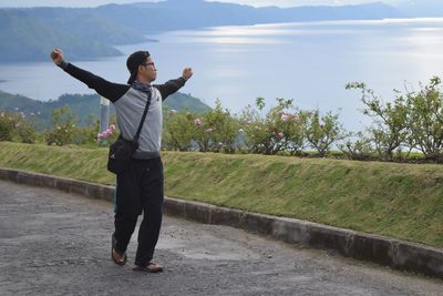 Full length of man standing on field against sky