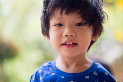 Close-up portrait of cute boy with messy hair