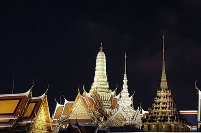 Illuminated temple against sky at night