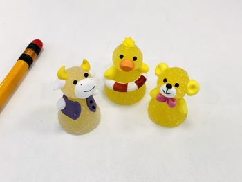 High angle view of toys on table against white background