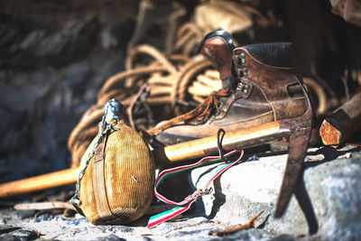 Close-up of work tool with water bottle outdoors