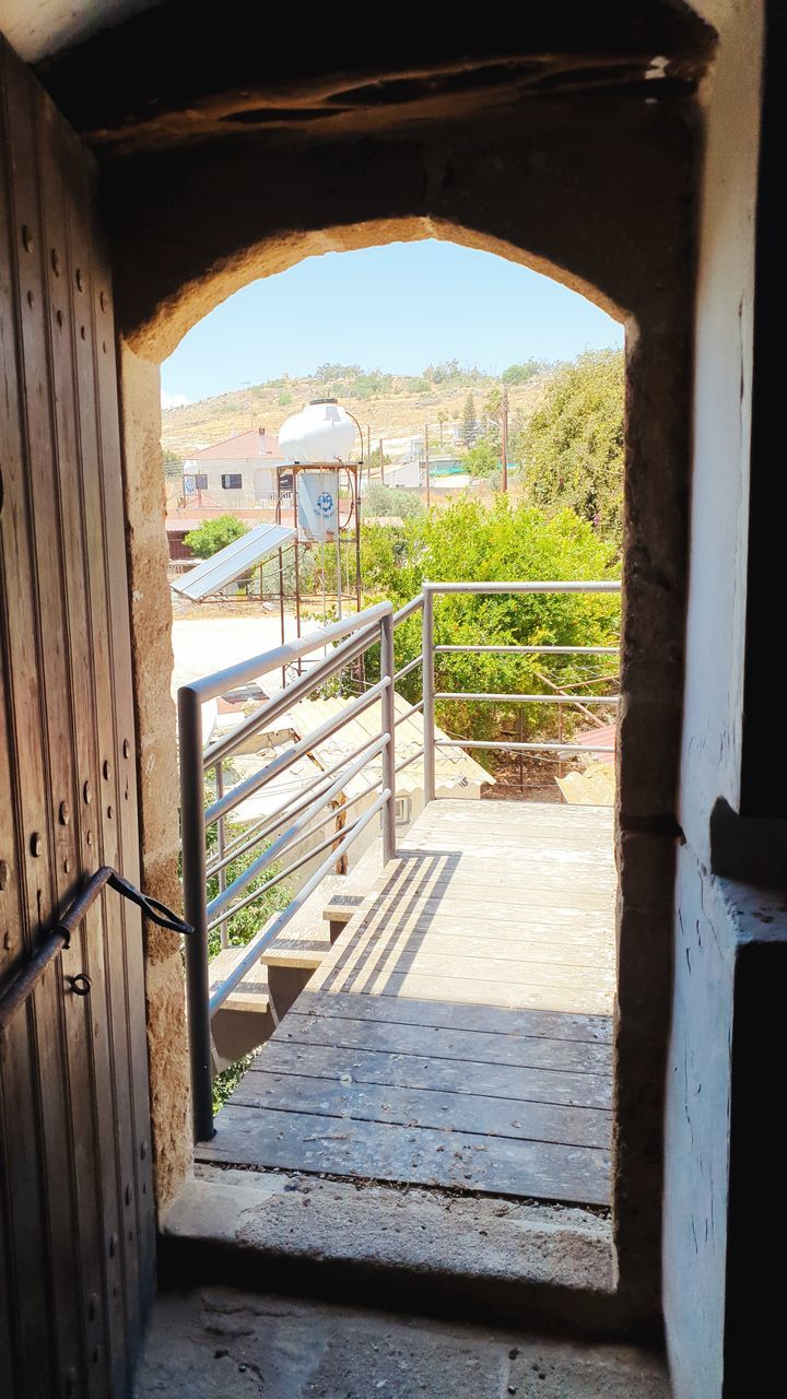 architecture, built structure, day, wood, house, no people, nature, sunlight, wall, railing, entrance, outdoors, arch, home, plant, building, door, gate, the way forward, bridge, staircase, open, shadow, sky