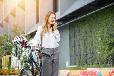 Portrait of young woman using mobile phone