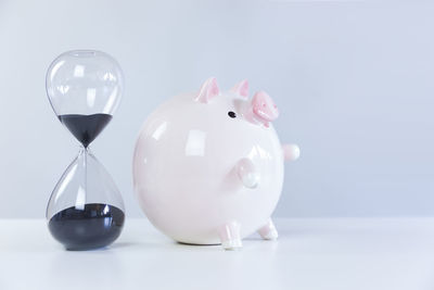 Close-up of clock on table against white background