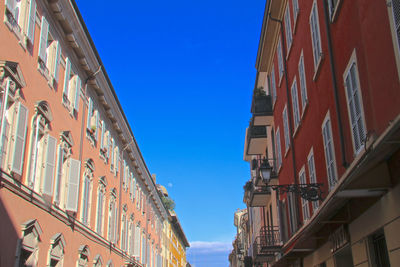 Low angle view of buildings against blue sky