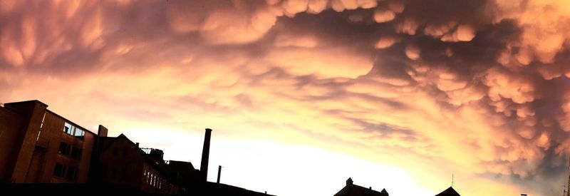 Low angle view of silhouette buildings against sky during sunset