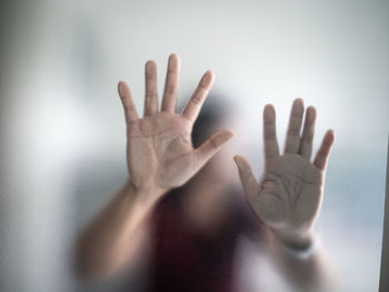 Close-up of hand touching glass