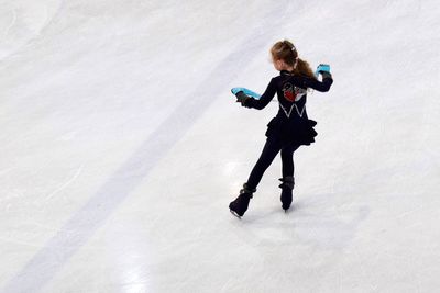 Rear view full length of girl ice-skating