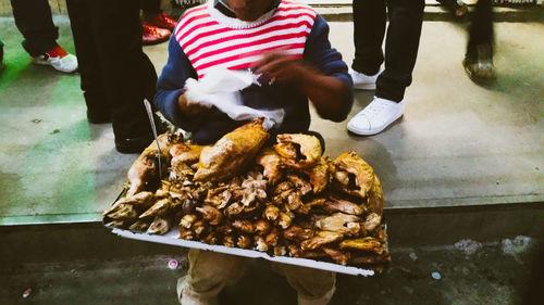 People standing on barbecue grill