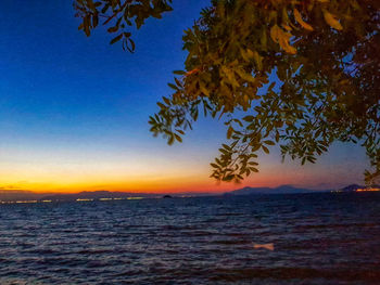 Scenic view of sea against clear sky at sunset