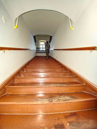 Rear view of man on staircase in building