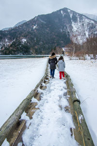 People standing on snow covered mountain