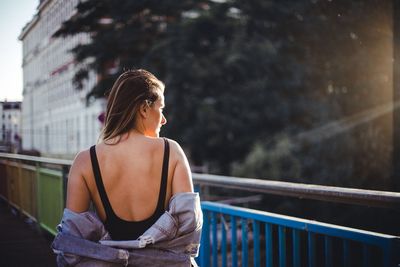 Rear view of woman looking at camera