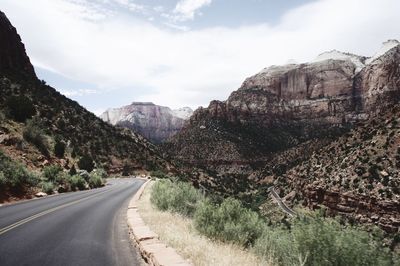 Road amidst mountains against sky