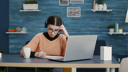 Young woman using laptop at home