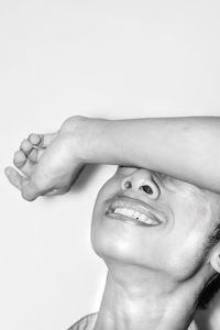 Close-up portrait of smiling man against white background