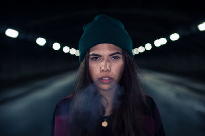 Portrait of young woman at night