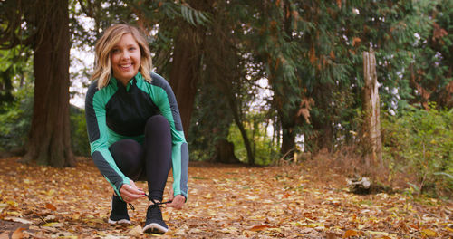 Portrait of smiling young woman in forest