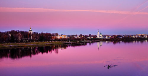 Reflection of buildings in city at dusk