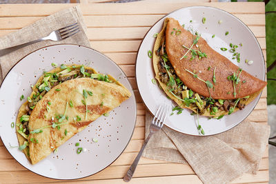 Vegan pancakes filled with mushrooms, pea sprouts and avocado. healthy breakfast for two persons 