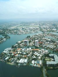 High angle view of townscape by sea against sky