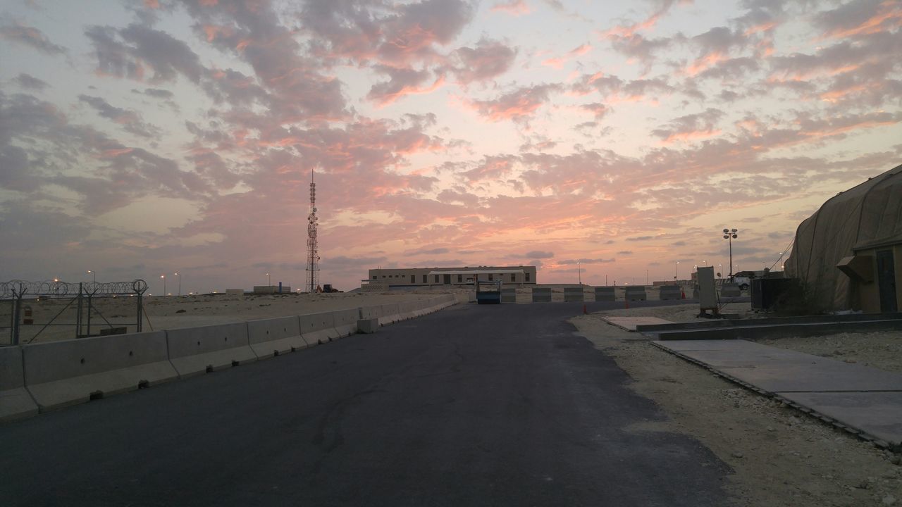 sunset, sky, the way forward, built structure, architecture, cloud - sky, building exterior, road, tranquility, street, orange color, scenics, nature, tranquil scene, outdoors, beauty in nature, empty, transportation, silhouette, no people