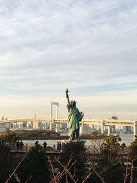 Statue of liberty with city in background