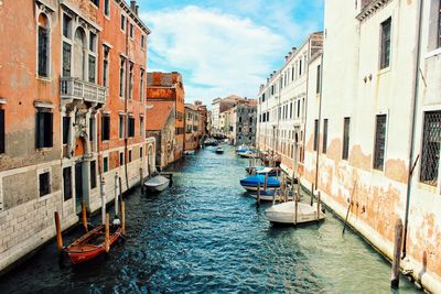 View of boats in canal along buildings