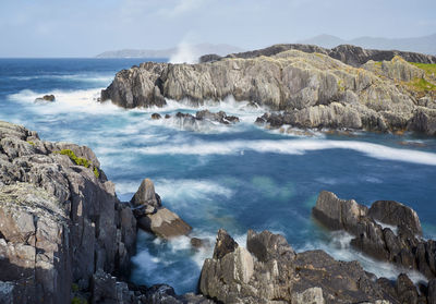 Panoramic view of sea and mountains against sky