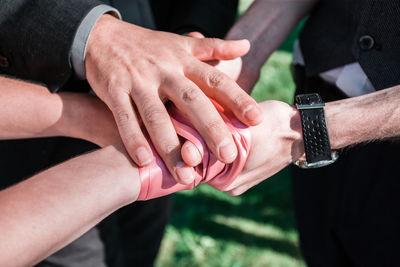 Midsection of couple holding hands