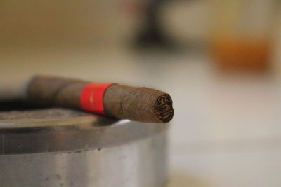 Close-up of cigar on table