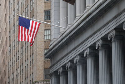 Low angle view of flag against buildings in city