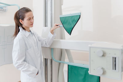 Portrait of smiling female doctor examining chemical in clinic